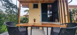 a wooden table and two chairs on a patio at Studio em Machico in Machico