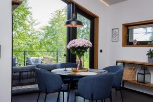 a dining room with a table and chairs and a window at Travy in Yaremche