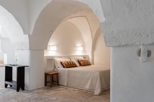 a bedroom with a bed with two pillows on it at Masseria Borgo San Marco in Fasano +109 photos