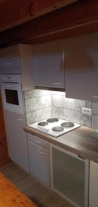 a kitchen with a white stove and a counter at Chalet pour 2 personnes à 700m du Centre Ville in Gérardmer +5 photos