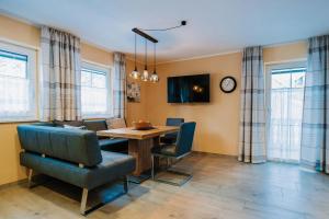 a living room with a dining room table and chairs at App. Marlos in Leisach