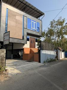 a house on the side of a street at Oblue Private Pool Villa in Cherai Beach