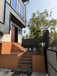 a house with a staircase leading to the front door at Oblue Private Pool Villa in Cherai Beach