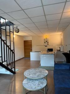 a living room with a table and a counter at Oblue Private Pool Villa in Cherai Beach