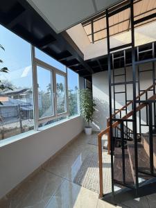 a staircase in a room with windows and a stair case at Oblue Private Pool Villa in Cherai Beach