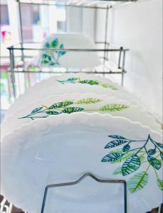 a white cake with green leaves on a table at Vogue- Lavish collection in Zirakpur