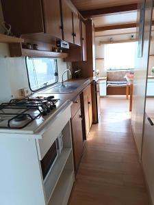 a kitchen with a sink and a stove top oven at Mobil home inter in Berck-sur-Mer
