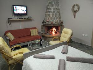 a living room with a couch and a fire place at Studio Giannis, a breath away from Athens! in Neméa