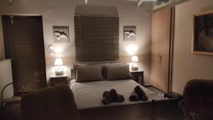 a bedroom with a bed with two shoes on it at Studio Giannis, a breath away from Athens! in Neméa