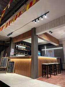 a restaurant with a bar with chairs and tables at Yellow Umbrella Hostels in Cebu City