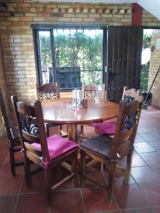 a wooden dining room table with chairs and a table and a window at Casa Oliva in Sáchica