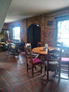 a dining room with a wooden table and chairs at Casa Oliva in Sáchica