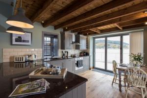 a kitchen with a counter and a table with chairs at Tangle Tower in Inverness