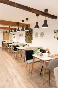 a dining room with tables and chairs and lights at Bellu Suites by GuestPro in Guimarães