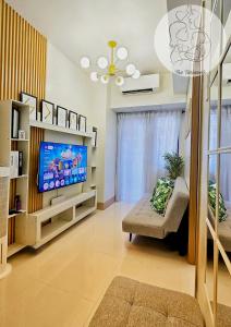 a living room with a tv and a couch at The Turianos in Manila