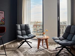 a living room with two chairs and a table at Numa Amsterdam Docklands in Amsterdam +35 photos