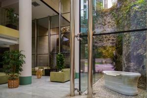 a bathroom with a bath tub in a building at Blau Gran Hotel Las Caldas, a member of Radisson Individuals in Las Caldas