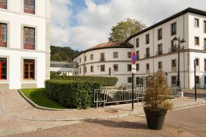 a street with buildings and a potted plant in front at Blau Gran Hotel Las Caldas, a member of Radisson Individuals in Las Caldas