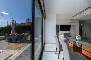 a kitchen and dining room with sliding glass doors leading to a patio at Villa Liana by LovelyStay in Ponta do Sol