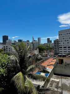 a view of a city skyline with a palm tree at Casa Selarón - Lapa centro in Rio de Janeiro