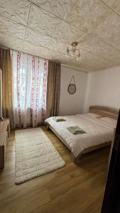 a bedroom with a bed and a ceiling at Sylvia Residence in Lupeni