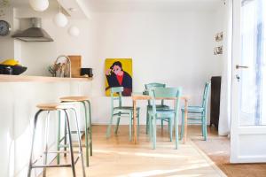 a dining room with a table and chairs at Malot 34 in Montreuil