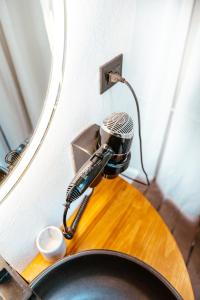 a hair dryer sitting on top of a bathroom sink at AMANI Casa Suite in San Rafael +9 photos