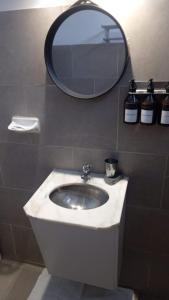 a bathroom with a sink and a mirror at Alojamiento San Nicolas in La Rioja