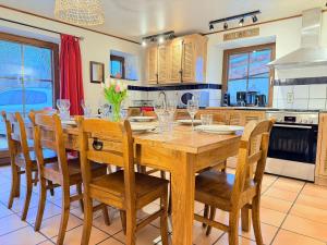 a dining room with a wooden table and chairs at La Ressource in Cherain