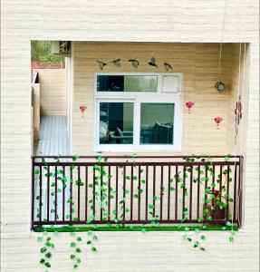 a balcony with a window and a plant at Vogue- Lavish collection in Zirakpur