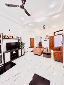 a living room with a flat screen tv and furniture at Rehan Sunset Villa in Negombo