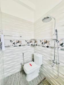 a white bathroom with a shower and a toilet at Rehan Sunset Villa in Negombo +47 photos