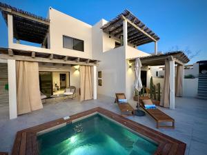a villa with a swimming pool and a house at Casa del Mar - Luxury Seaside Villa in Boca de la Vinorama