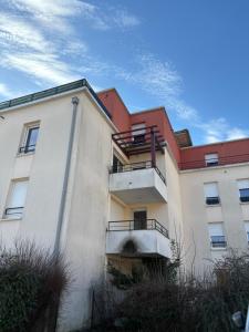 a white building with a red roof at Appartement T2 Confort in Albertville
