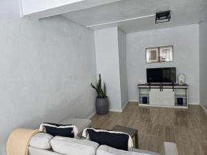 a living room with a couch and a tv at Jean Olive in Castries
