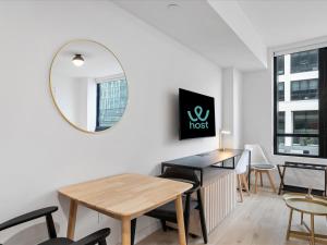 a dining room with a table and a mirror at Stylish Studio in Downtown Location in Miami