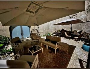 a group of chairs and tables with umbrellas at Relais Palazzo Duomo in Nola