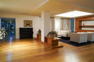 a living room with a couch and a piano at Blau Hotel Las Caldas, a member of Radisson Individuals in Las Caldas