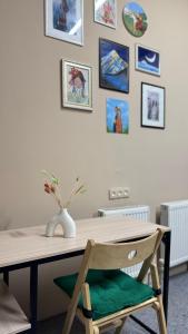 a dining room table with a vase on top of it at Sky Tau Hostel in Almaty