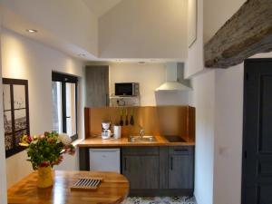 a kitchen with a sink and a wooden table at Gites LA CHAUMONIERE in Chaumont-sur-Loire +17 photos