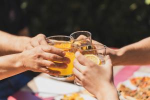a group of people holding up glasses of beer at Camping Ridaura in Llagostera +9 photos