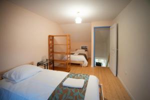 a bedroom with a bed and a ladder in it at T3 Cosy - Art Déco in Villefranche-de-Rouergue