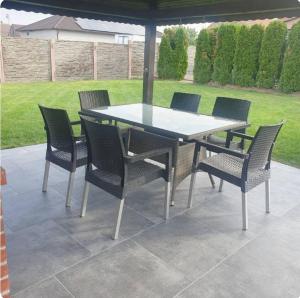 a dining table and chairs on a patio at Parnica Home 4 in Dudeştii Noi
