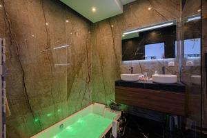 a bathroom with two sinks and a tub and a mirror at Romantic getaway with Balneo Centre Lorient in Lorient