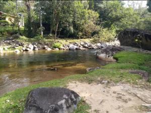 a river with rocks in the middle of it at Pousada Céu aberto in Núcleo Mauá