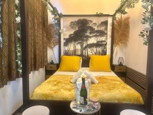 a bedroom with two beds with yellow pillows and a table at Romantic getaway with Balneo Centre Lorient in Lorient