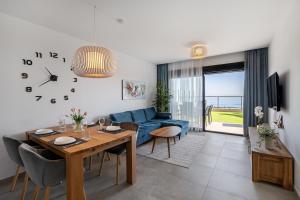 a living room with a table and a blue couch at Iconic Sea View in Gran Alacant