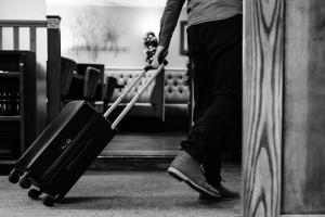 a person pulling a suitcase in an airport at Crown Lodge Hotel in Wisbech