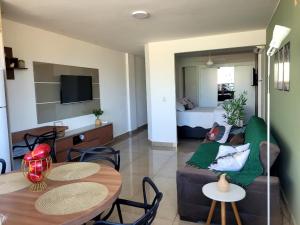 a living room with a couch and a table at Flat Praia Itacoatiara in Niterói