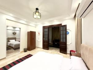 a bedroom with a bed and a room with a bed and a mirror at TriPyramids Suites in Cairo